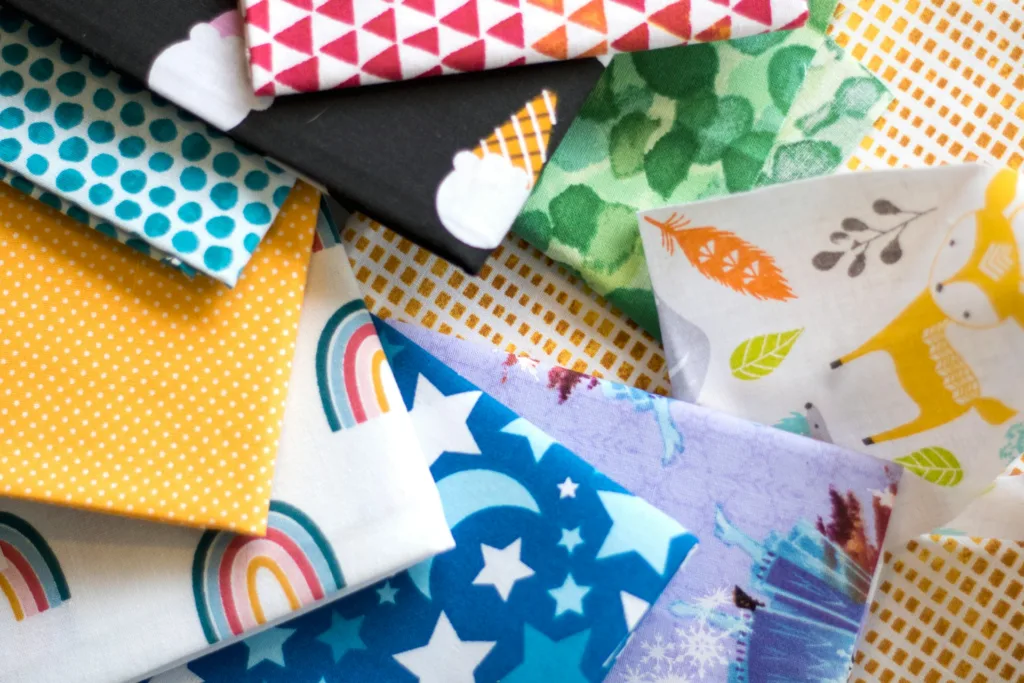 A pile of different colored fabrics on top of each other
